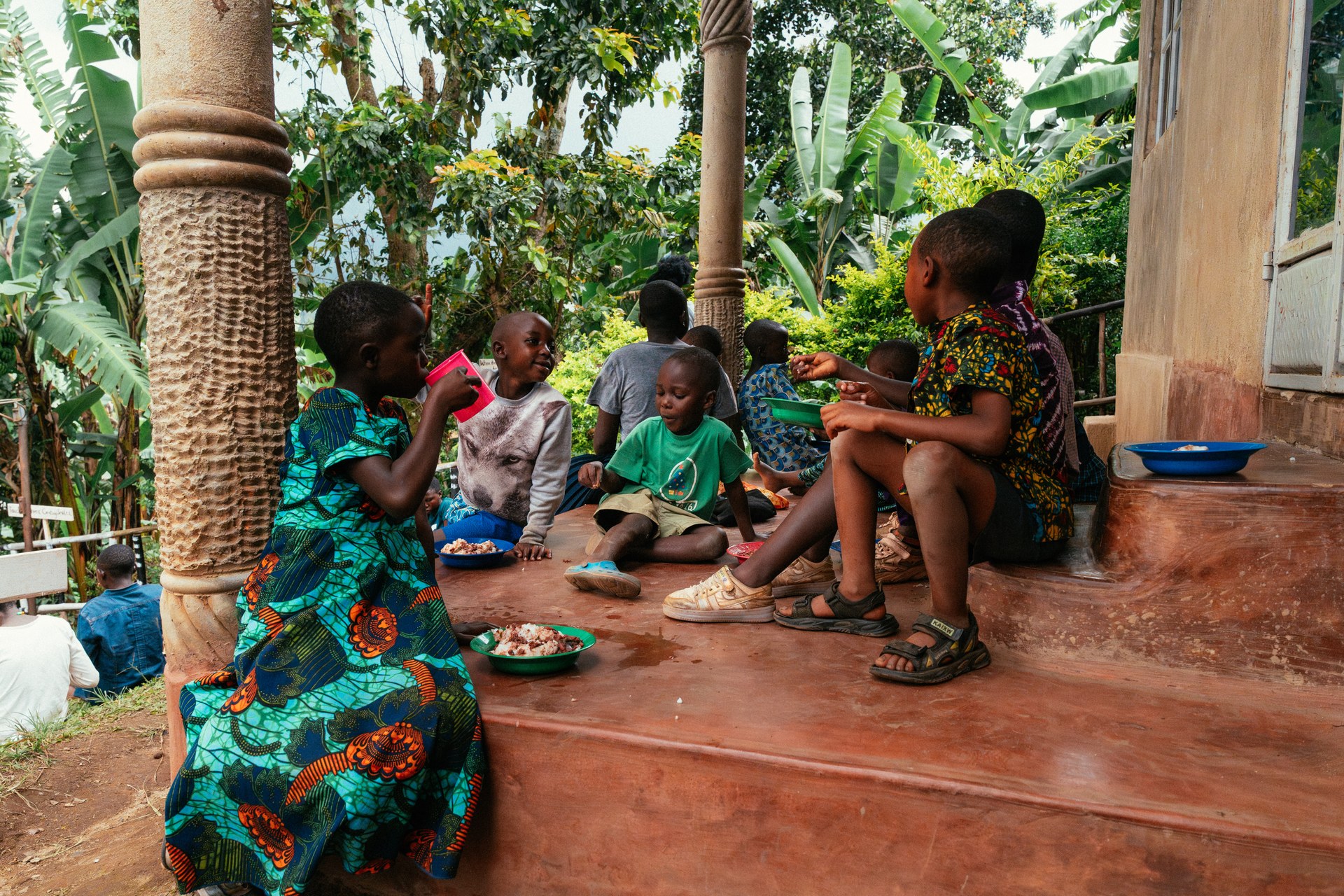 Children sharing a meal on the veranda