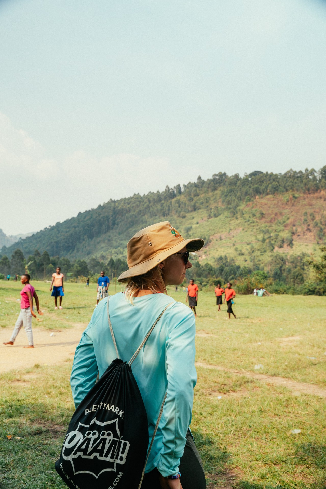 Visitor watching children play in Buhoma
