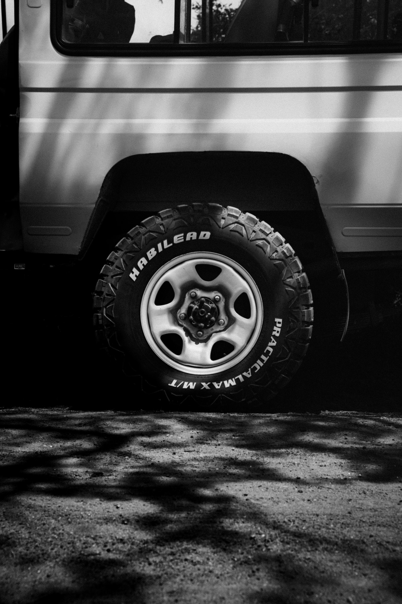 Off-road tyres in the shadow of a safari bus