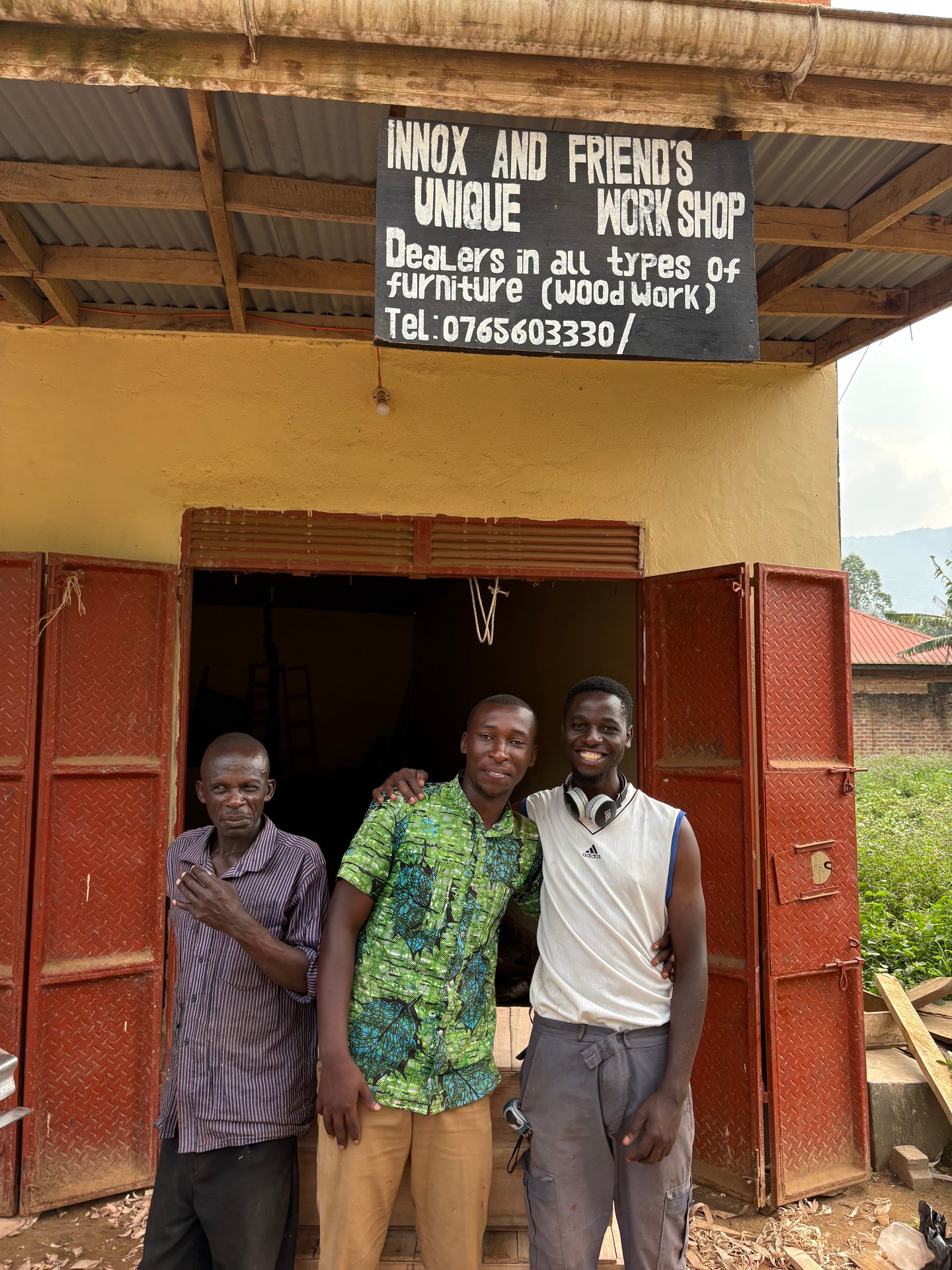 Three men at their carpentry workshop in Buhoma