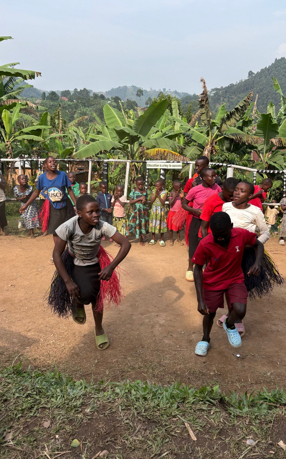 Children performing traditional dance at Buhoma orphanage — photographed on location, January 2026 (GPS: -0.9617, 29.6109)