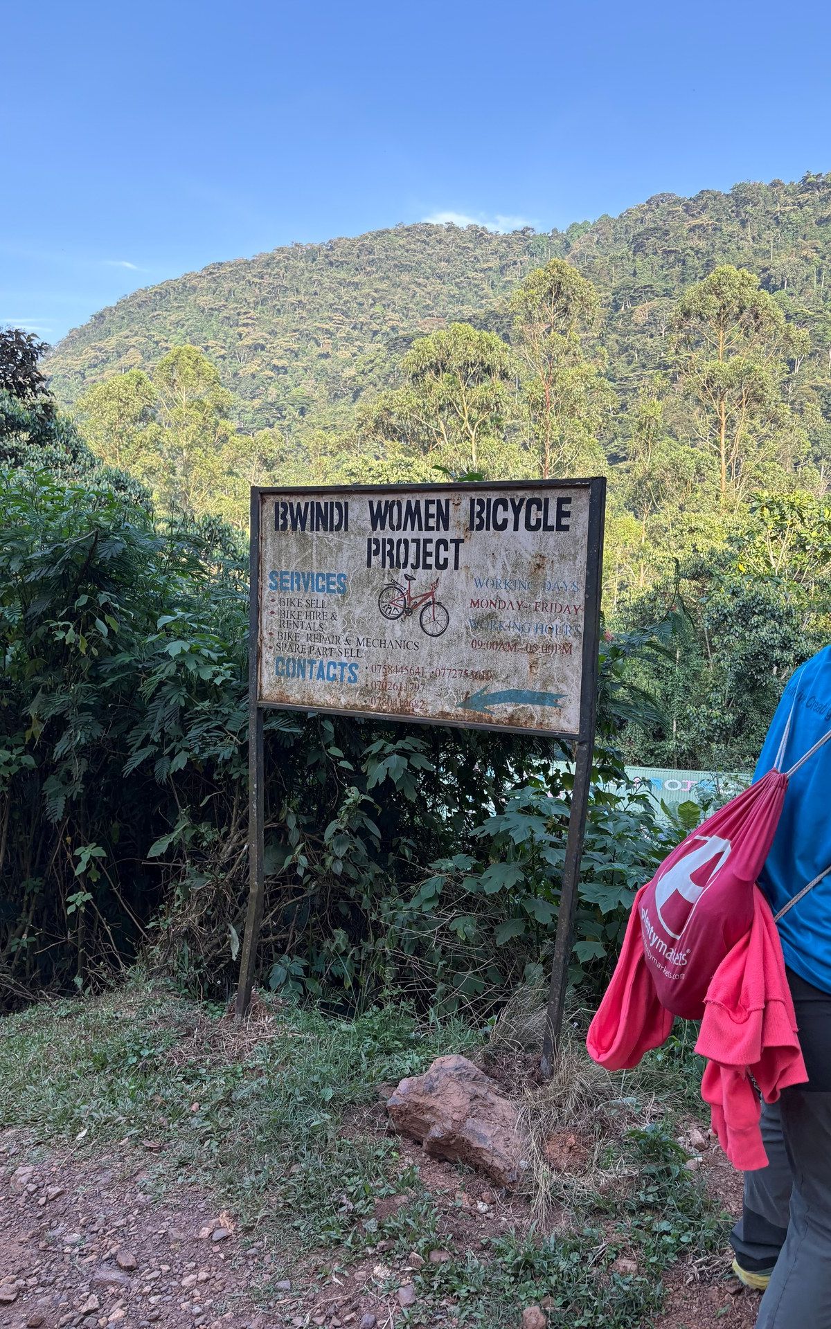 Bwindi Women Bicycle Project sign in Buhoma — photographed on location, January 2026 (GPS: -0.9857, 29.6165)