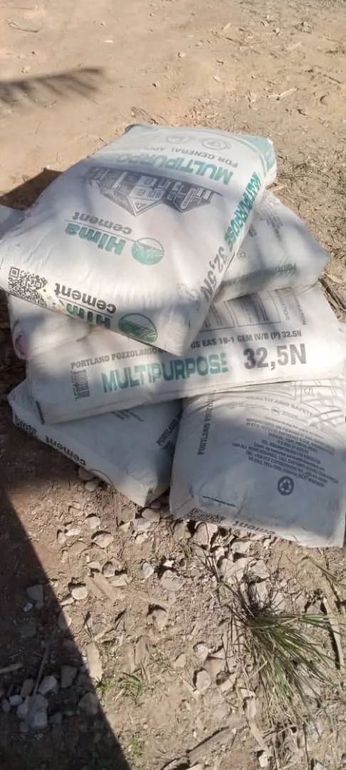 Stacked cement bags on red laterite soil at the HopeKitchen construction site in Buhoma. Photo: Mark Suer