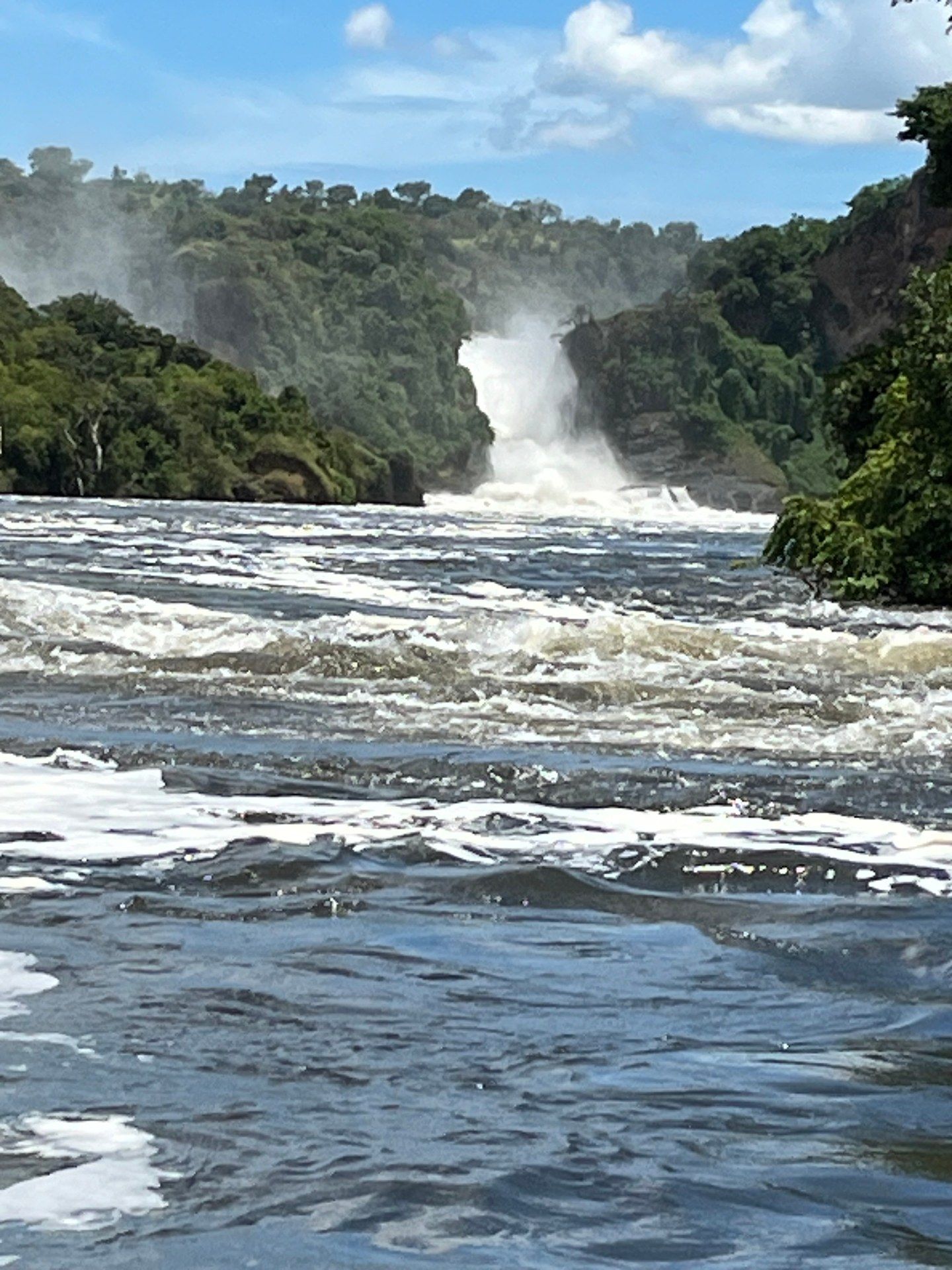 The Murchison Falls waterfall as seen from a boat on the Victoria Nile — the Nile forces itself through a narrow gorge in a powerful cascade, Murchison Falls National Park, Uganda, October 2024